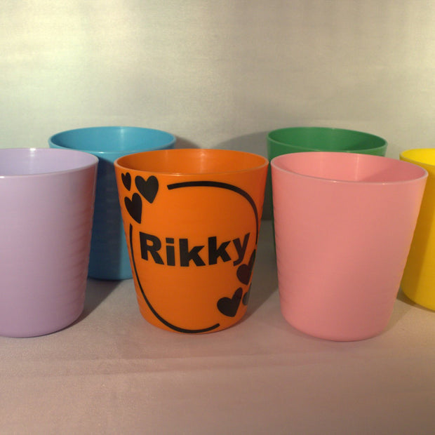 Kleurrijke traktatiebekers met gepersonaliseerde hartjes beker met naam Rikky in oranje – uitdeelbeker verjaardag opvang
